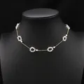 Gold plated chain necklace featuring iridescent crystal flowers and small white pearls - Crystal Loop Pearl Necklace