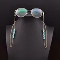 Bohemian turquoise stone eyeglass chain with golden metal links on a black bust - Turquoise Symmetrical Glasses Chain