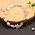 Detail of handmade Baroque pearl and pink crystal bracelet with gold clasp on wood base. - GB0171B