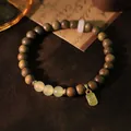 Vintage green sandalwood bracelet featuring Hetian jade beads and a golden Fu charm - Light Green Sandalwood Nephrite Jade Bracelet