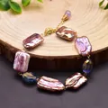 Detailed view of natural baroque purple pearl bracelet on a rustic wood slice - Multi-color Baroque Pearl Bracelet