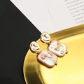 Elegant gold hammered stud earrings featuring iridescent rectangular natural baroque pearls - Purple Irregular Groove Studs