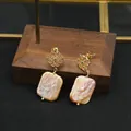 Exquisite baroque pearl earrings with gold openwork diamond top and elegant pinkish luster - Purple Emerald Hollow Lace Studs
