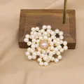 Elegant flower-shaped freshwater pearl brooch with pink center pearl on wooden stand - Double-Layer Pearl Flower Style (GO0332C)