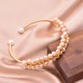 Handmade natural freshwater pearl elastic bangle with gold wire wrapping details - Hand-Wrapped Pearl Bangle / Pink