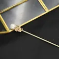 Vintage gold hair stick featuring a large natural pearl and intricate flower motifs - White Edison Pearl Hair Stick