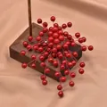 Elegant handmade red sea bamboo bead brooch with floral design on vintage wood display - Round Bead Branch Brooch