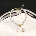 Natural freshwater pearl bracelet with butterfly pendant and gold bead accents - Bracelet / Gold
