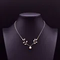 Elegant gold-plated vine necklace featuring white natural pearls displayed on black bust - White Pearl Leaf Pendant Necklace (ALGN0276)