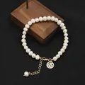 Elegant white natural pearl bracelet featuring a gold plated Fu character charm on a black background - Fu Luck Plate Bracelet / Fu Character Tag Style / Gold