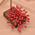 Elegant red flower brooch accessory made of sea bamboo beads on a wooden stand - Fat Rice Branch Brooch