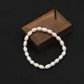 Elegant natural white oval pearl bracelet with a single gold bead accent for women - Simple Pearl Elastic Bracelet / Elastic Style / White