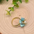 Retro turquoise and freshwater pearl ring on a natural wooden background - Turquoise Flower Shape Style