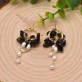 Handmade gold-tone baroque freshwater pearl earrings with irregular black stone charms - Black Agate