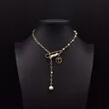 Natural pearl necklace with gold chain and coin pendant shown on black mannequin - Tag Pin Necklace