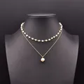 Elegant double-layered jewelry featuring a white pearl choker and a gold pendant chain. - Double Layer Wrapped Pearl Necklace