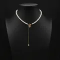 Elegant natural pearl choker necklace featuring a delicate gold heart pendant on a display - Heart Zirconia Toggle Pearl Necklace