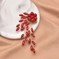 Close-up detail of handmade red bead brooch with gold wire weaving and elegant finish. - Thin Rice Branch Brooch
