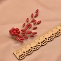Vintage ethnic branch brooch with red sea bamboo beads and wooden ruler for scale - Thin Rice Branch Brooch