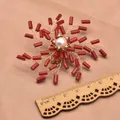 Vintage ethnic brooch with a natural white pearl and red sea bamboo branch design - Windfire Wheel Brooch