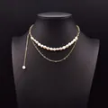 Elegant double-layer necklace with white freshwater baroque pearls and gold heart chain. - White Pearl Double Layer Necklace