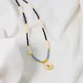 Elegant natural pearl necklace featuring black beads and a chic golden teardrop pendant - Natural Pearl Necklace with Avocado Pendant (ALGN0276)