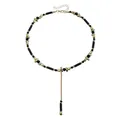 Vue détaillée d'un collier bohème en forme de Y avec des perles noires et dorées - Noir