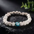 Detailed close-up of a white marble bead bracelet featuring a turquoise evil eye bead. - Evil Eye Style (S1347-A)