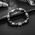 Close-up detail showing the silver Buddha head and Bagua charms on a beaded bracelet - Black Bead Style (S483-B)