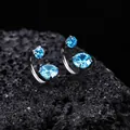 Macro view of titanium horseshoe earrings with light blue crystals on volcanic rock. - Sea Blue (XT070-C)
