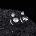 Close-up view of polished titanium horseshoe rings with sparkling round cubic zirconia stones - White (XT070-A)