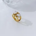 Macro detail of a 18K gold-plated double band ring with pear and oval cubic zirconia - Size 6 / Dual Stone Open Style / Gold