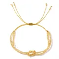 Gold beaded bracelet with central knot design and adjustable cord on white background. - Gold Figure-Eight Knot Style (FG-B24070801A) / Gold