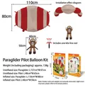 Inflatable cartoon paraglider pilot balloon set with kite reel and product packaging. - Paraglider Pilot Set