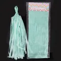 Detail view of mint green tissue paper tassel with DIY garland packaging - Neon Blue