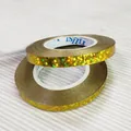 Macro view of gold holographic glitter ribbon rolls for party and wedding decor - 10m / Laser Gold