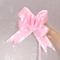 Detailed view of a large pink double-color decorative pull bow for gift packaging and weddings - Stripe Pattern / Pink