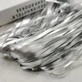 Close-up macro view of shimmering silver metallic foil fringe streamers for party decor - 1*2M / Silver