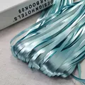 Close-up detail of chrome metallic tinsel fringe curtain for party wall decoration - 1*2M / Sky Blue