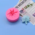 Flower-shaped silicone mold displayed with a finished light blue gypsum blossom on blue background - 3D Star Flower Style (32-3) / 6.7cm Diameter / Pink