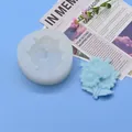 Detail view of a floral silicone mold next to a finished blue flower bouquet craft. - Daisy Cluster Style (32-1) / Diameter 7.1cm / White