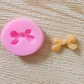 Detailed view of pink bow-tie silicone mold with a finished fondant bow decoration - Single Small Bowknot