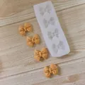 Detail view of bow-shaped silicone mold with finished fondant decorations on wood - 4-Cavity Rectangular Bowknot