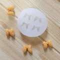 Silicone bow mold for fondant and chocolate cake decor with finished peach-colored bows. - 4-Cavity Round Bowknot