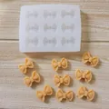 Close-up detail of bow-tie silicone mold with finished decorative fondant pieces - 9-Cavity Rectangular Bowknot