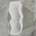Close-up detail of wavy silicone mold featuring Lucky It phrase for DIY candle making - Fuck It