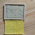 Detailed view of a bamboo texture silicone mold with a yellow finished sample. - Bamboo