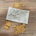 Detailed view of peony flower silicone mold with yellow fondant floral samples on wood background. - Three Flowers