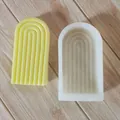 Detailed macro view of arched silicone mold alongside its yellow geometric candle output - New High Arch