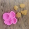 Detail view of pink seashell silicone mold with four finished yellow fondant shells - 4-Cavity Shell (Pink)
